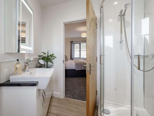 a white bathroom with a sink and a shower at 2 Bed in Usk 82391 in Trostrey