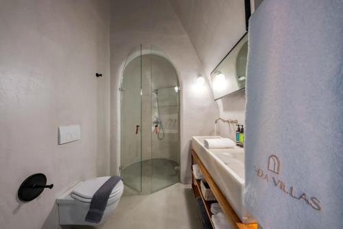 a bathroom with a shower and a toilet and a sink at Luxurious Santorini Masionette Villa - 1 Bedroom - Astounding Caldera Sea Views and Private Outdoor Hot Tub - Fira in Fira