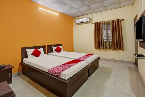Ένα ή περισσότερα κρεβάτια σε δωμάτιο στο OYO Flagship Sanskar Garden