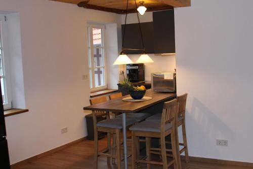 a kitchen with a wooden table and chairs at Bettches Hof in Kirchhain