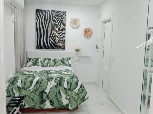 a bedroom with a bed with a zebra picture on the wall at Moneiba Centro in Córdoba