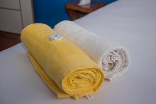 a rolled up towel sitting on top of a table at Platina House in Maputo
