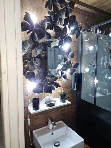 a bathroom with a sink and a mirror at le petit chalet cevenol in La Barriére