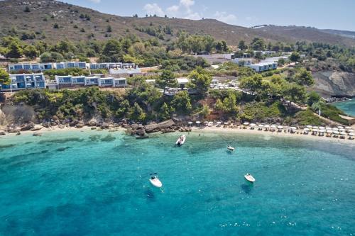 an aerial view of a beach with boats in the water at White Rocks Hotel Kefalonia in Lassi