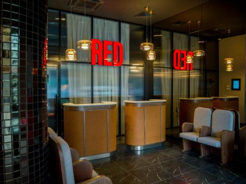 a restaurant with a red sign on the window at Radisson RED Belgrade in Belgrade