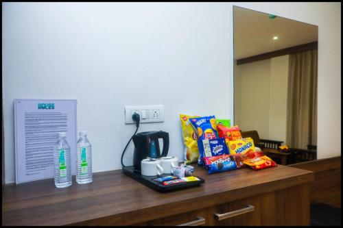 a counter with snacks and a coffee maker on it at The Byke Suraj Club, Junagadh in Junagadh