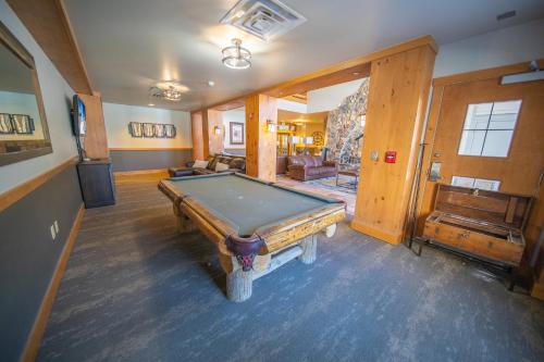 a room with a pool table in a house at Expedition Station 8589 in Keystone