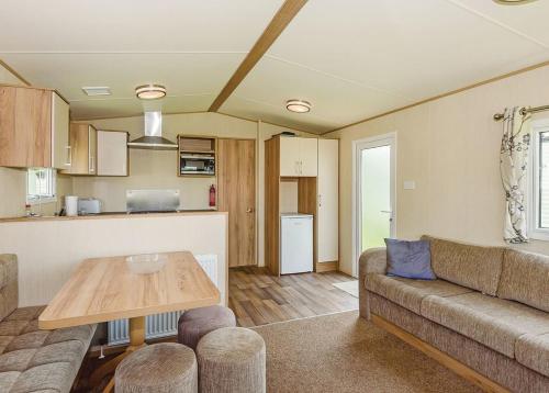 a living room with a couch and a table at Riverside Caravan Park in Bognor Regis