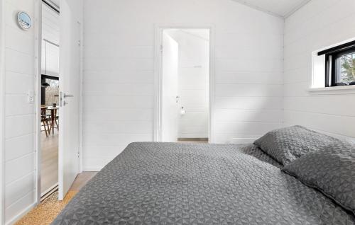 a white bedroom with a bed and a window at Awesome Home In Stege With Kitchen in Stege