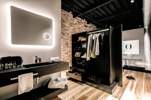 a bathroom with a black sink and a brick wall at HO Paseo de Almería in Almería