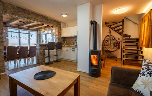 a living room with a wood stove in it at Awesome Home In Aljmas in Aljmaš