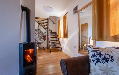a living room with a wood stove in a room at Awesome Home In Aljmas in Aljmaš