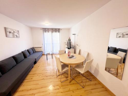 a living room with a couch and a table at Smile Apartments in Canillo