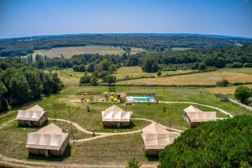 an aerial view of a farm with tents in a field at JOINS! Grenache in Saint-Germain-et-Mons
