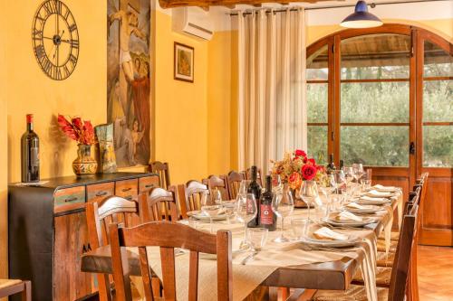 a dining room with a long table with wine glasses at PODERE BAIOCCO TENUTA in Città della Pieve