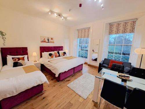 a bedroom with two beds and a living room at Angel x Kings Cross Hub in London