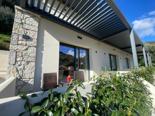 a view of a house with a pergola at Tramonto Maisonettes & Suites in Parga