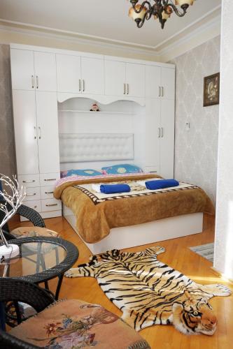 a bedroom with a bed and a zebra rug at Belas House With Terrace in Kutaisi