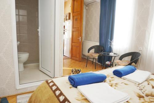 a room with two beds and a bathroom with a toilet at Belas House With Terrace in Kutaisi