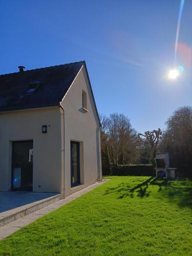 une maison blanche avec une grande pelouse dans l'établissement Maison au calme et proche de la mer, à Arzal
