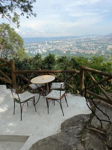 a table and chairs with a view of a city at HACIENDA EL ENSUEÑO in Floridablanca