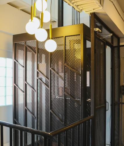 a room with a large metal wall with lights at 2BR Stylist Rare Find China Town in Bangkok