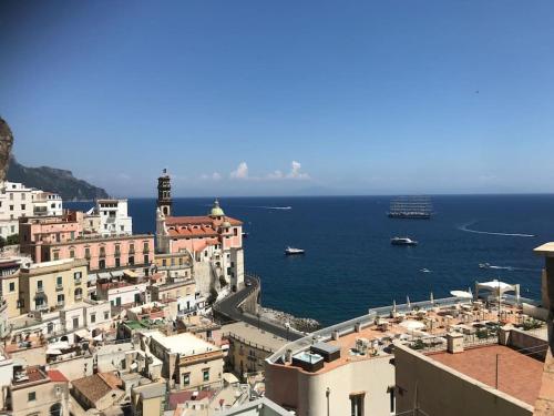 a view of a city with a cruise ship in the water at Panoramic house Atrani 5 Amalfi Antica appartamenti in Atrani