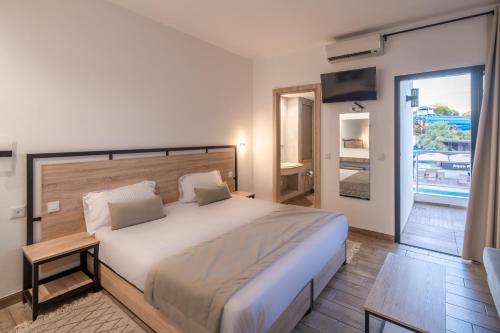 a bedroom with a large bed and a balcony at Acquaviva village in Gammarth
