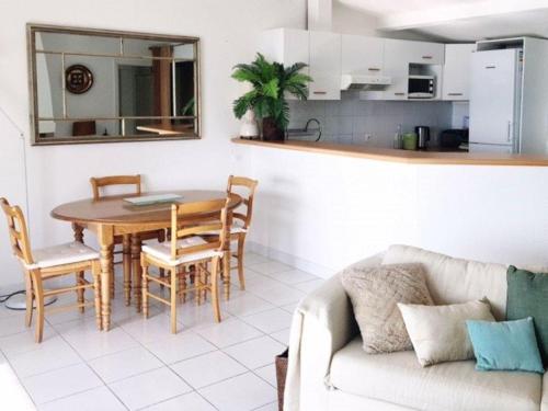 un salon avec une table et une cuisine dans l'établissement Superbe villa avec immense terrasse et vue sur mer, à 200m des plages - 2 chambres climatisées - FR-1-100-172, à Cavalaire-sur-Mer