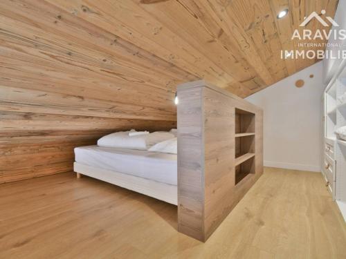 a bedroom with a bed with a wooden ceiling at Appartement Le Grand-Bornand, 3 pièces, 6 personnes - FR-1-391-182 in Le Grand-Bornand