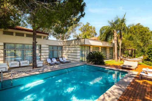 a swimming pool in the backyard of a house at Kempinski Hotel The Dome Belek in Belek