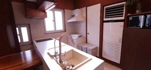 a kitchen with a sink and a counter top at Studio Sum in Seoul
