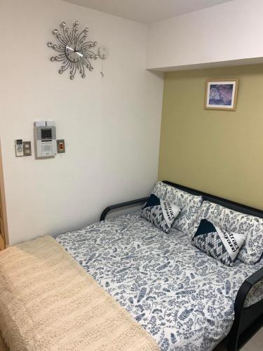 a bedroom with a bed with a comforter and pillows at 诚信东新宿 in Tokyo