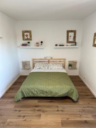 1 dormitorio con 1 cama y suelo de madera en Venice Rooms, en Favaro Veneto