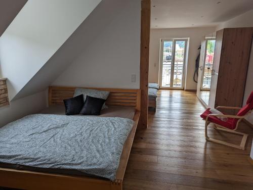 a bedroom with a bed and a staircase at Ferienwohnung Blick Schloss Prunn in Riedenburg