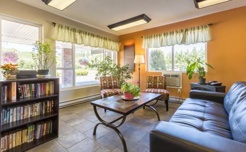 a living room with a couch and a table at Bon Voyage Inn in Prince George