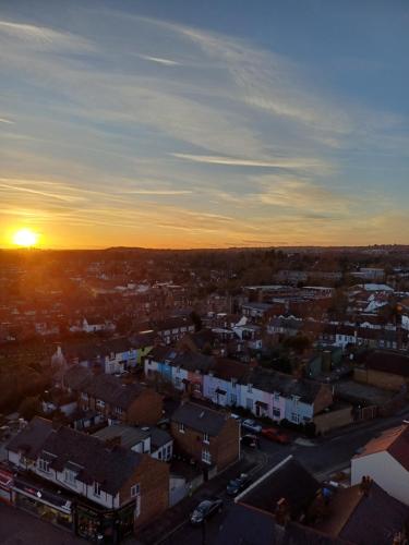 a view of a city with the sunset in the background at Luxury Apartment With Stunning Views on 10th floor in Edgware
