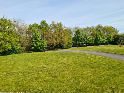 eine gewundene Straße durch ein Grasfeld in der Unterkunft L'Ecrin - Rubis in Châteaubriant