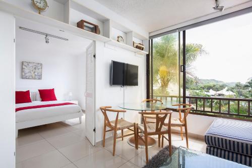 a room with a glass table and chairs and a bed at Breakers 421 in Durban