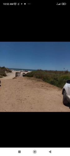 a car parked on a sandy beach near the ocean at Lo de Yamaha in Aguas Dulces