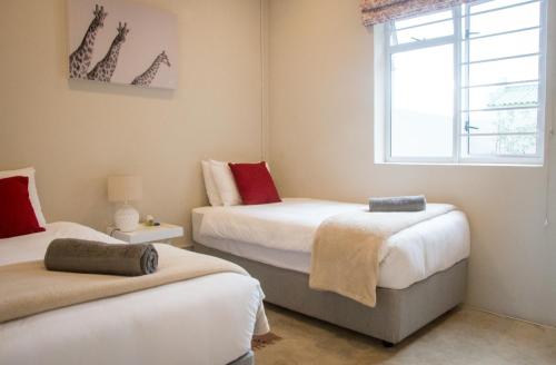 a bedroom with two beds and a window at Moortop Cottages in Elgin