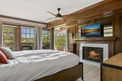 a bedroom with a bed and a fireplace at Lake Reflection Point Upscale Lake House 4 Bed and 4.5 Bath in Lake Arrowhead