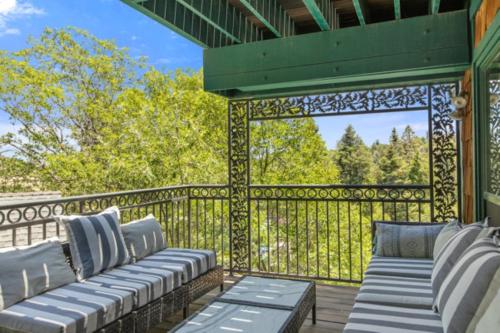 a gazebo with two couches on a deck at Lake Reflection Point Upscale Lake House 4 Bed and 4.5 Bath in Lake Arrowhead