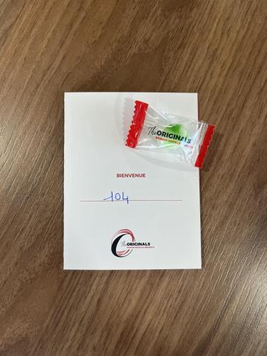 a package of toothpaste and a box on a table at The Originals City, Hôtel Mâcon Nord in Mâcon