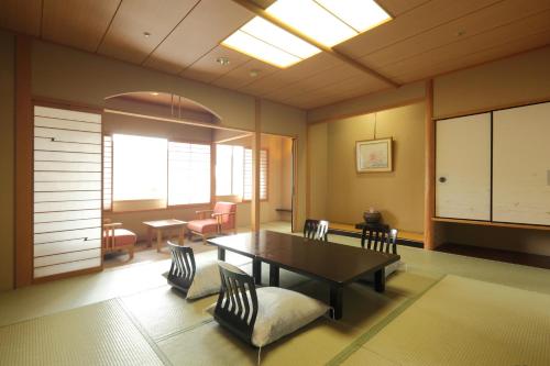 a dining room with a table and chairs at Hotel Futaba in Yuzawa