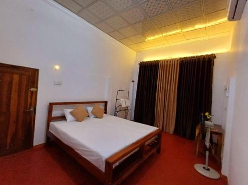 a bedroom with a large bed in a room at Turtle Island Cabana in Tangalle