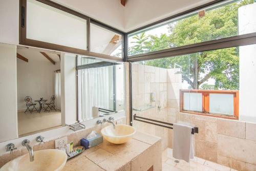a bathroom with a sink and a large window at Party house for family! in Tarcoles