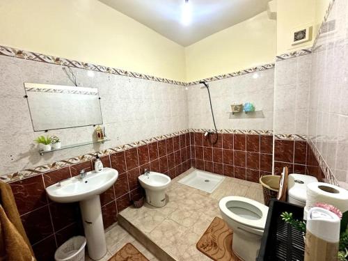a bathroom with a toilet and a sink at Spacious fantastic closeby airport and city in Marrakesh