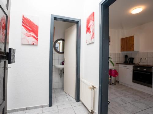 SR24 - Stilvolle Wohnung 2 in Herten في هيرتين: حمام مع باب مفتوح للمطبخ