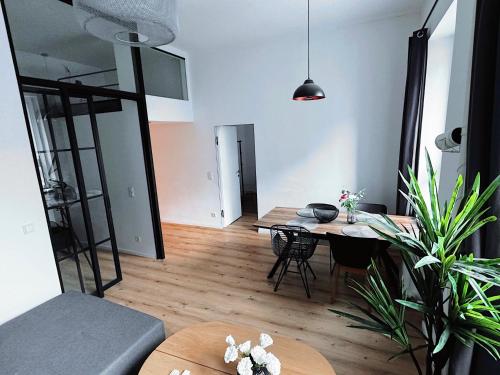 a living room with a table and a dining room at Inner City Design Loft in Innsbruck